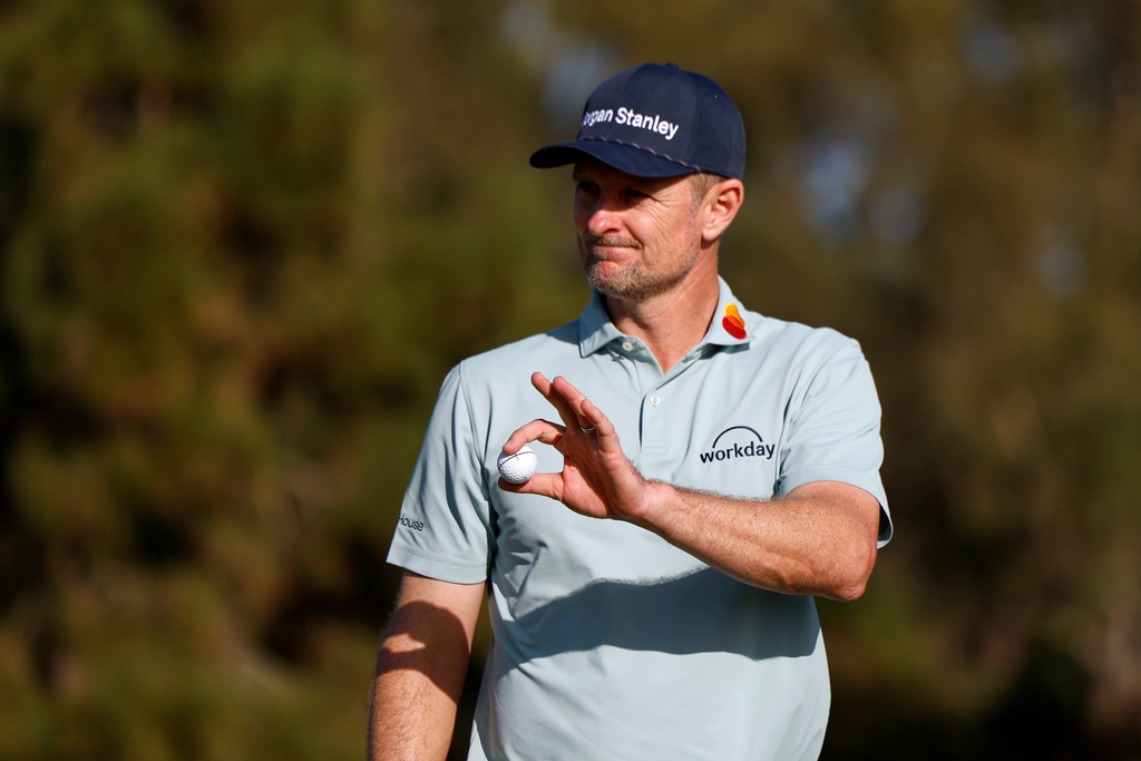 Justin Rose, of England, waves after finishing on the eighth hole on the North Course at Torrey Pines during the first round of the Farmers Insurance Open golf tournament Thursday, Jan. 29, 2026, in San Diego. (AP Photo/Caroline Brehman)