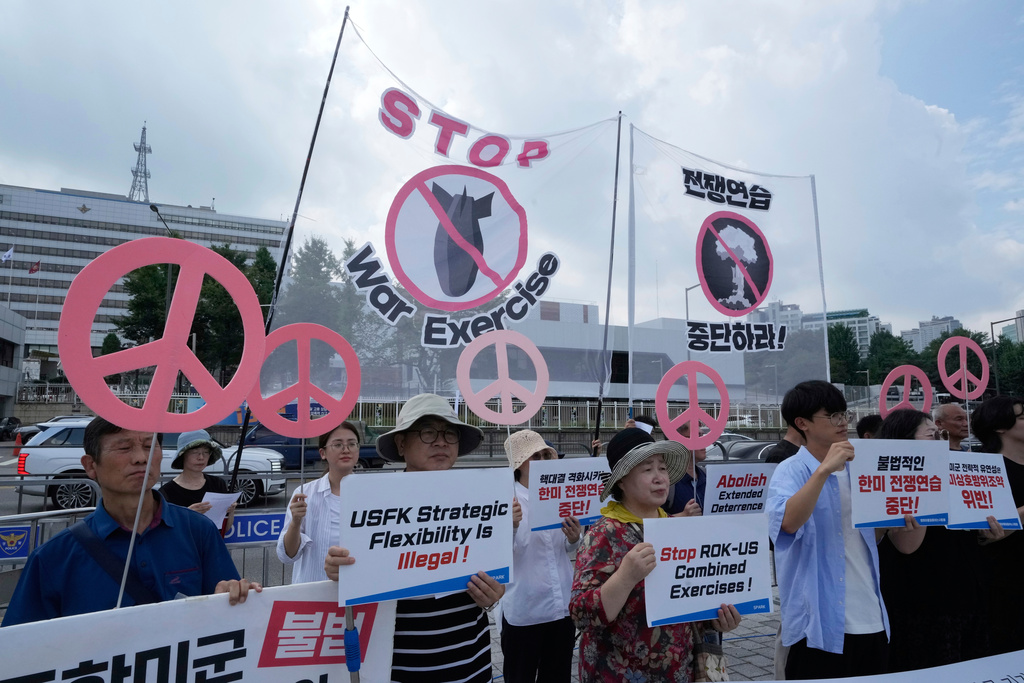 South Korean protesters stage a rally to oppose the joint military exercises, Ulchi Freedom Shield or UFS, between the U.S. and South Korea in front of the presidential office in Seoul, South Korea, Monday, Aug. 18, 2025. The banners read "Stop the military exercise between the U.S. and South Korea." (AP Photo/Ahn Young-joon)