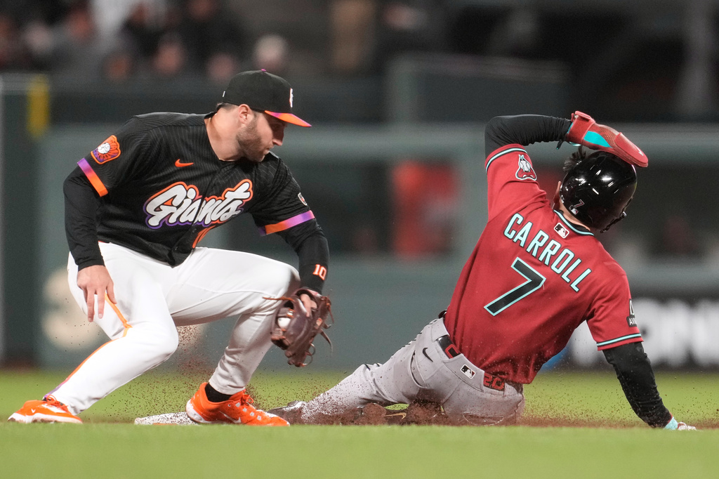 Arizona Diamondbacks' Corbin Carroll (7) steals second base against San Francisco Giants second baseman Casey Schmitt during the ninth inning of a baseball game Tuesday, May 26, 2026, in San Francisco. (AP Photo/Jeff Chiu)