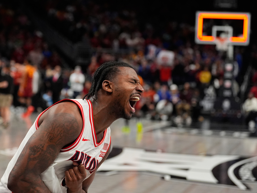 Arizona's Jaden Bradley celebrates after making the game-winning shot at the buzzer to defeat Iowa State during an NCAA college basketball game in the semifinal round of the Big 12 Conference tournament Friday, March 13, 2026, in Kansas City, Mo. (AP Photo/Charlie Riedel)