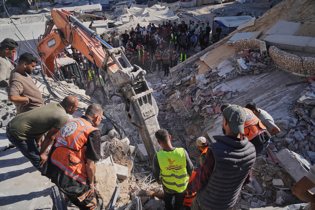 Palestinian civil defense crews search for bodies and survivors in the rubble of a collapsed building that housed displaced Palestinians and was heavily damaged during the Israel-Hamas war, in Gaza City, Wednesday, Sept. 16, 2026. (AP Photo/Jehad Alshrafi)
