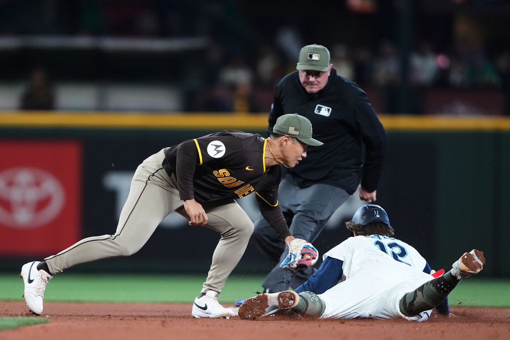 Seattle Mariners' Josh Naylor (12) steals second base in front of the tag from San Diego Padres second baseman Sung-Mun Song as Mariners' Julio Rodríguez steals third base during the eighth inning of a baseball game, Saturday, May 16, 2026, in Seattle. (AP Photo/Lindsey Wasson)