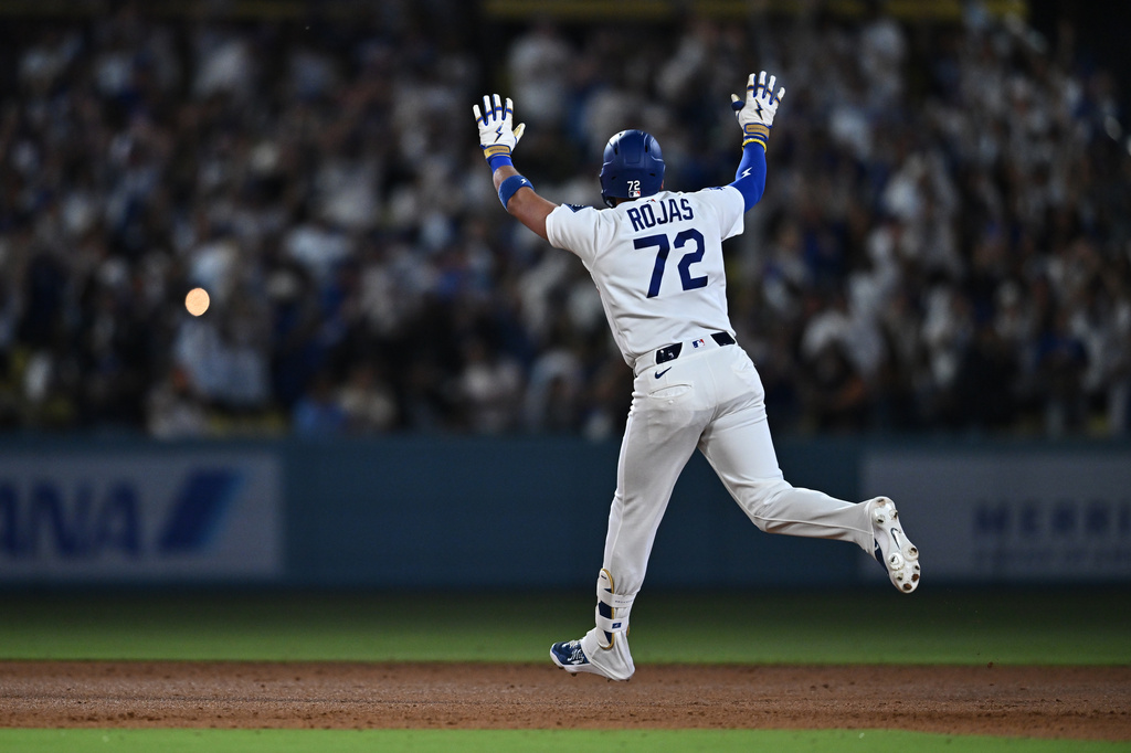 Los Angeles Dodgers' Miguel Rojas gestures after hitting a home run during the seventh inning of a baseball game against the Tampa Bay Rays, Monday, June 15, 2026, in Los Angeles. (AP Photo/William Liang)