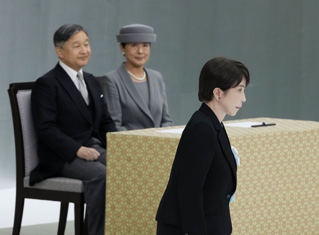 Japan’s Prime Minister Sanae Takaichi, right, walks past Japan's Emperor Naruhito and Empress Masako, after delivering a speech during the memorial service marking the 81st anniversary of Japan's surrender in the World War II, at the Nippon Budokan hall Saturday, Aug. 15, 2026, in Tokyo. (Ichiro Banno/Kyodo News via AP)