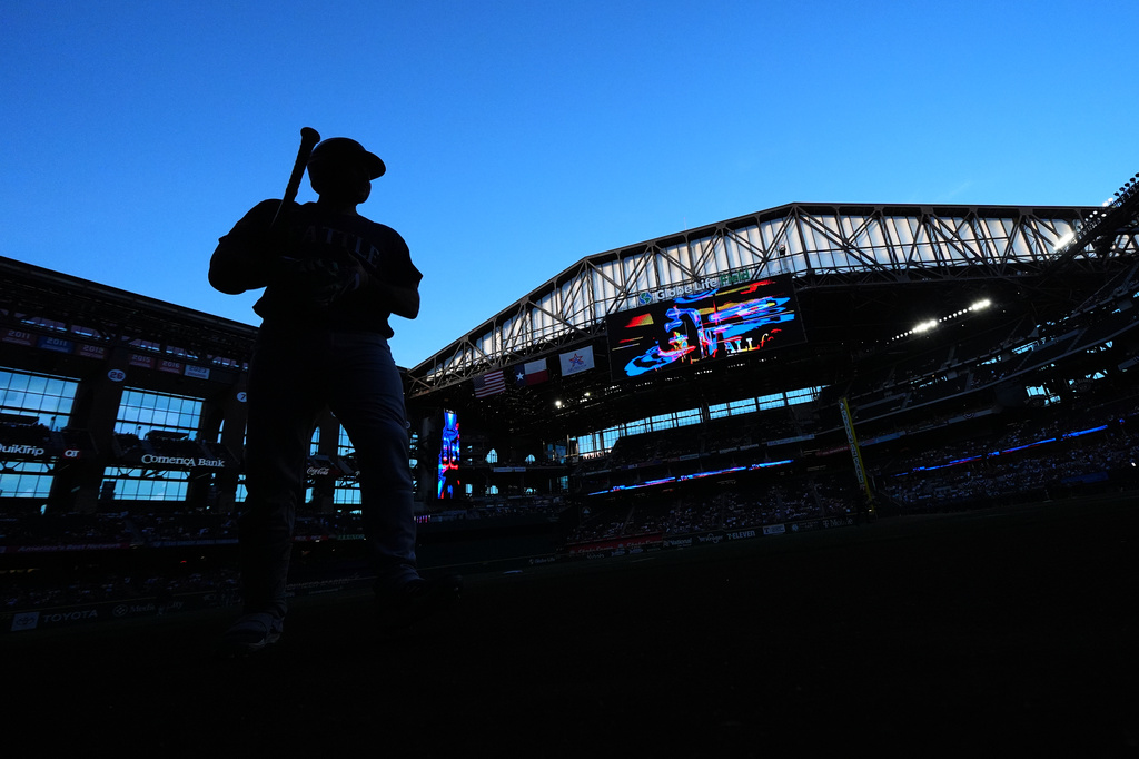 Seattle Mariners' Cal Raleigh walks to the on deck circle before the start of a baseball game against the Texas Rangers, Monday, April 6, 2026, in Arlington, Texas. (AP Photo/Julio Cortez)