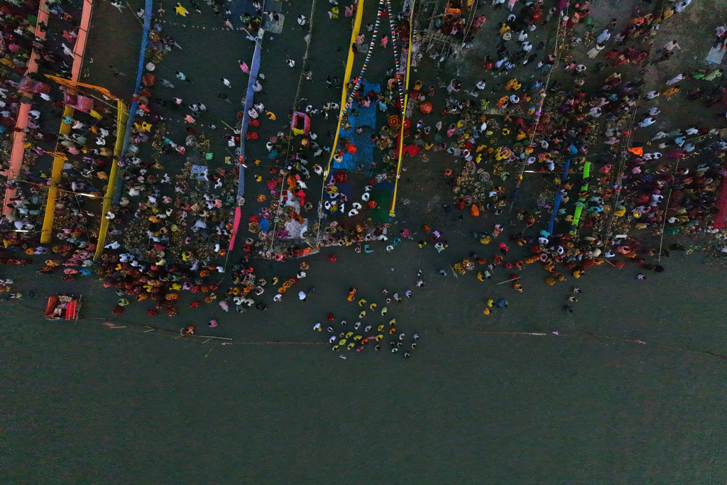 Indian Hindu devotees perform rituals in the the river Brahmaputra during the Chhath Puja festival in Guwahati, India, Monday, Oct. 27, 2025. (AP Photo/Anupam Nath)