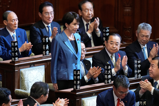 Lawmakers applaud as Sanae Takaichi, standing, was elected as Japan's new prime minister during the extraordinary session of the lower house, in Tokyo, Japan, Tuesday, Oct. 21, 2025.(AP Photo/Eugene Hoshiko) Lawmakers applaud as Sanae Takaichi, standing, was elected as Japan's new prime minister during the extraordinary session of the lower house, in Tokyo, Japan, Tuesday, Oct. 21, 2025.(AP Photo/Eugene Hoshiko)