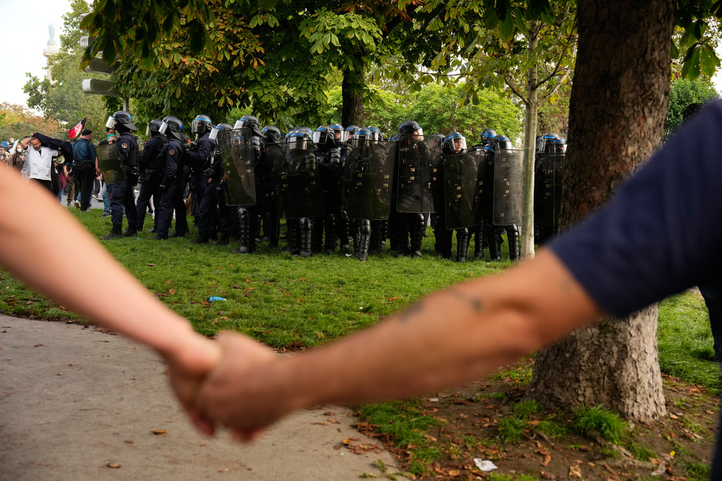 Protesters face police during a demonstration against under-resourced schools, in Paris, Tuesday, Oct. 6, 2026. (AP Photo/Teresa Suarez)