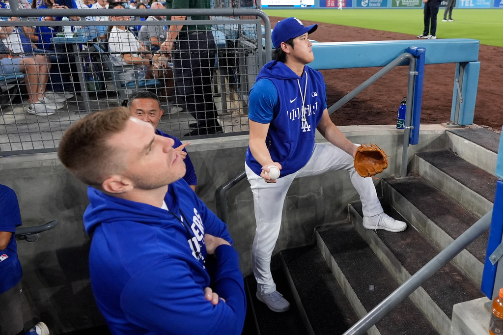 Los Angeles Dodgers' Freddie Freeman, left, and Shohei Ohtani watch from the dugout during the first inning of a baseball game against the Cincinnati Reds, Wednesday, Sept. 9, 2026, in Los Angeles. (AP Photo/Mark J. Terrill)