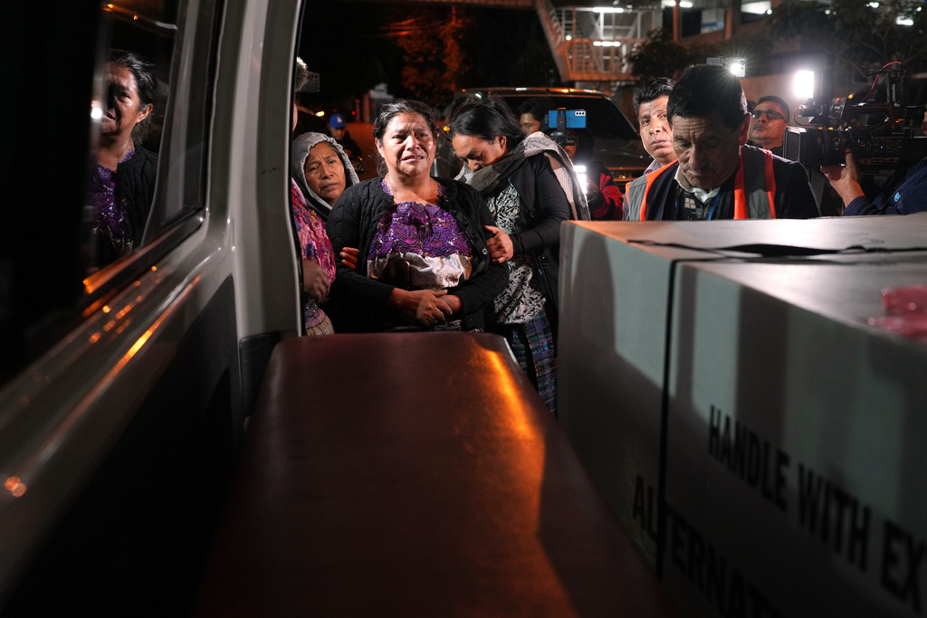 Vilma Pérez cries next to the coffin of her daughter Maria Florinda Ríos Perez, who was killed in Indiana, at La Aurora International Airport in Guatemala City, Sunday, Nov. 23, 2025. (AP Photo/Moises Castillo)