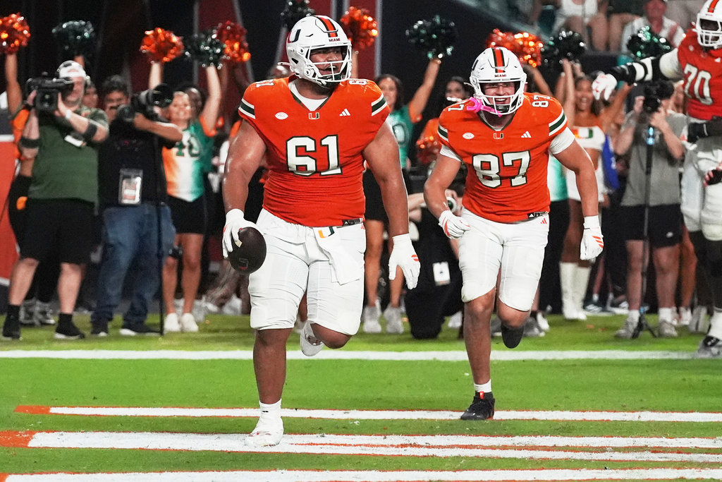 Miami offensive lineman Francis Mauigoa (61) celebrates after scoring a touchdown during the second half of an NCAA college football game against Syracuse Saturday, Nov. 8, 2025, in Miami Gardens, Fla. (AP Photo/Marta Lavandier)