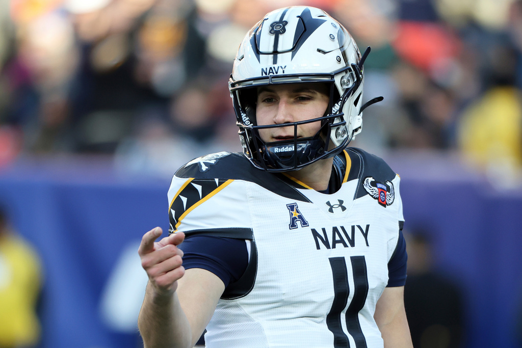 FILE - Navy quarterback Blake Horvath (11) warms up before of an NCAA college football game against Army, Saturday, Dec. 14, 2024, in Landover, Md. (AP Photo/Daniel Kucin Jr., File)