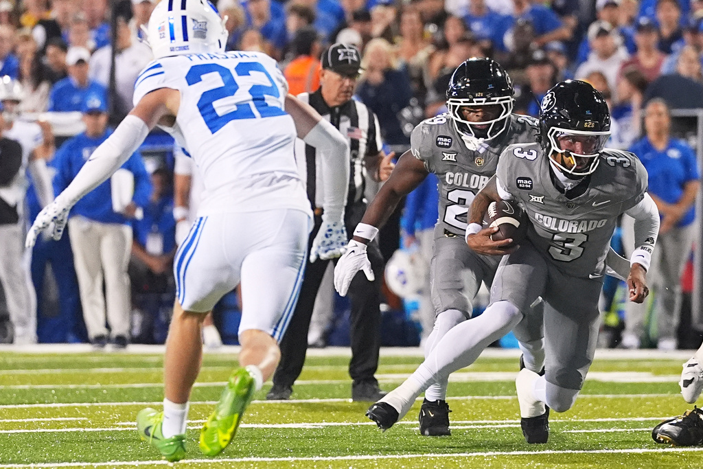 Colorado quarterback Kaidon Salter runs for a short gain as Brigham Young safety Tommy Prassas covers in the first half of an NCAA college football game Saturday, Sept. 27, 2025, in Boulder, Colo. (AP Photo/David Zalubowski)