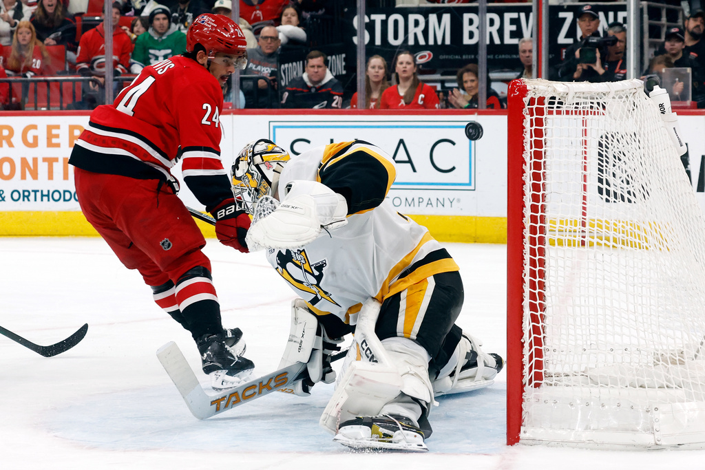 Carolina Hurricanes' Seth Jarvis (24) beats Pittsburgh Penguins goaltender Stuart Skinner (74) but misses the net during the second period of an NHL hockey game in Raleigh, N.C., Wednesday, March 18, 2026. (AP Photo/Karl DeBlaker)