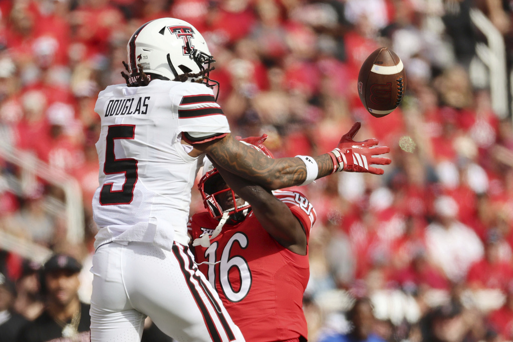 Utah cornerback Blake Cotton, right, breaks up a pass intended for Texas Tech wide receiver Caleb Douglas during the first half of an NCAA college football game Saturday, Sept. 20, 2025, in Salt Lake City, Utah. (AP Photo/Jeffrey D. Allred)