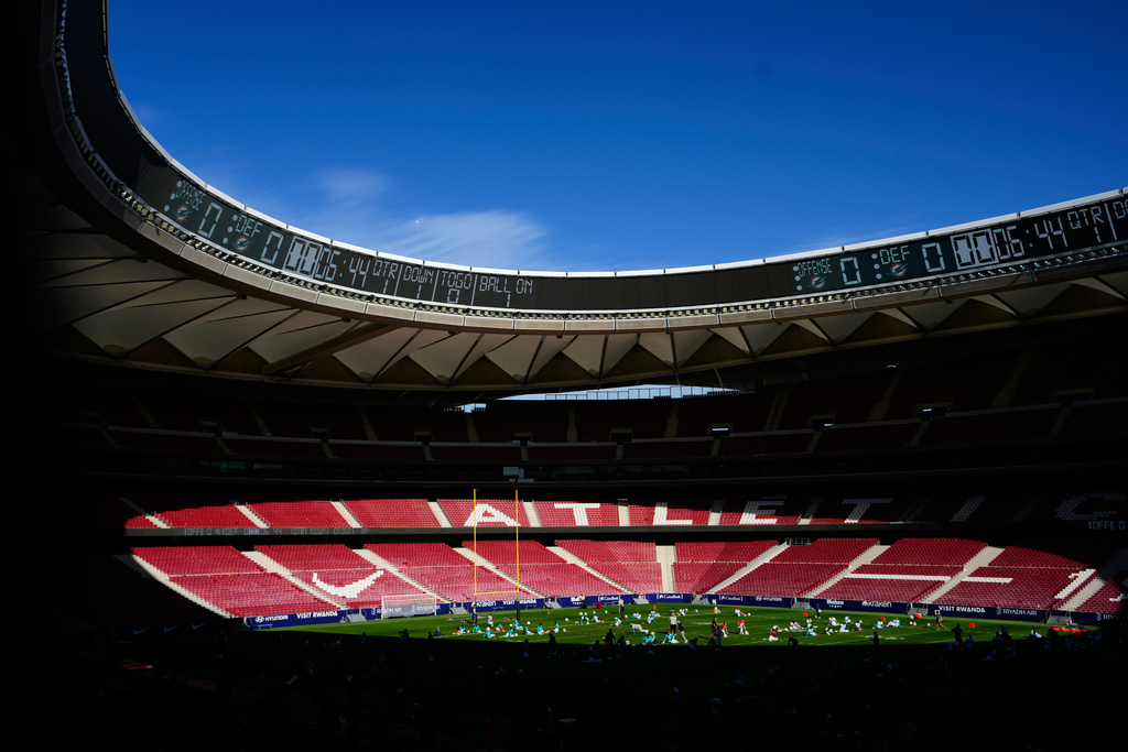 Miami Dolphins players warm up during a training session in Madrid, Spain, Wednesday, Nov. 12, 2025, ahead of Sunday's NFL football game against Washington Commanders. (AP Photo/Manu Fernandez)