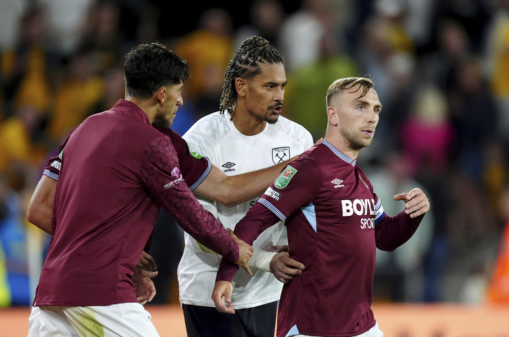 West Ham United's Jarrod Bowen, right, is pulled away from the fans after an argument at the final whistle in the English League Cup second round soccer match against the Wolverhampton Wanderers, Tuesday, Aug. 26, 2025, at Molineux Stadium in Wolverhampton, England. (Mike Egerton/PA via AP)