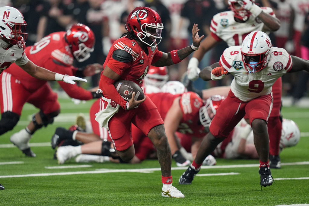 Utah quarterback Devon Dampier (4) runs in for a touchdown against Nebraska during the second half of the Las Vegas Bowl NCAA college football game Wednesday, Dec. 31, 2025, in Las Vegas. (AP Photo/John Locher)