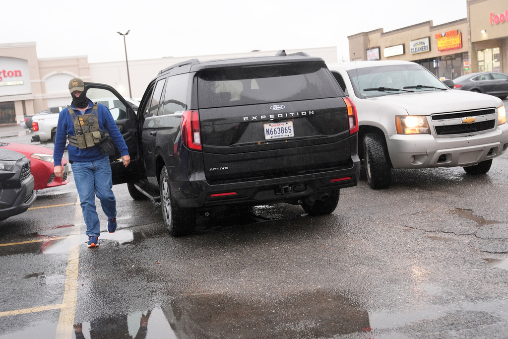 A Customs and Border Protection agent exits a vehicle after agents apprehended two people during an operation Thursday, Dec. 4, 2025, in Kenner, La. (AP Photo/Gerald Herbert)