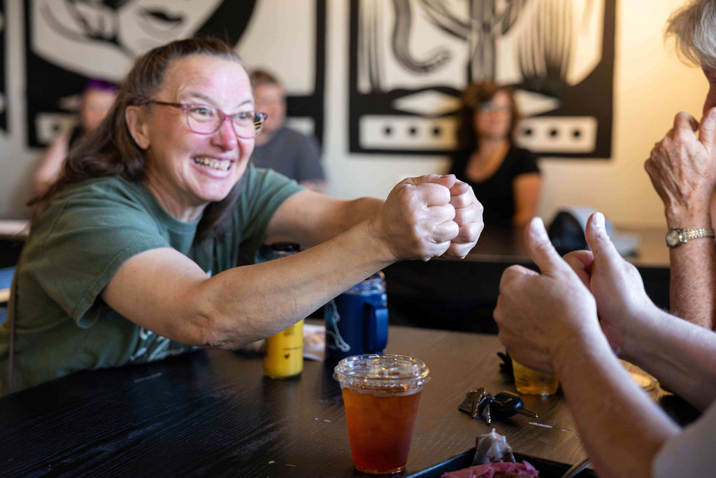 People attend a weekly meet up called "Sign Squad" at the Woodstock Cafe on June 10, 2025, in Portland, Ore. (Allison Barr/The Oregonian via AP)