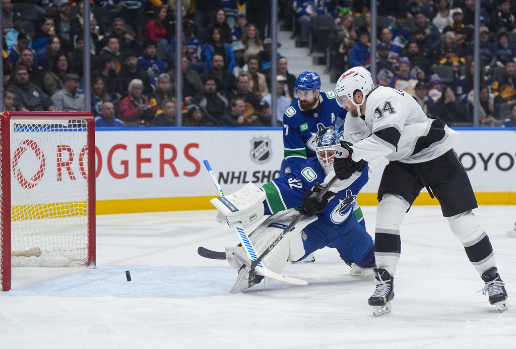 Los Angeles Kings' Alex Laferriere (14) scores against Vancouver Canucks goalie Kevin Lankinen (32) during the second period of an NHL hockey game, in Vancouver, on Tuesday, April 14, 2026. (Darryl Dyck/The Canadian Press via AP)