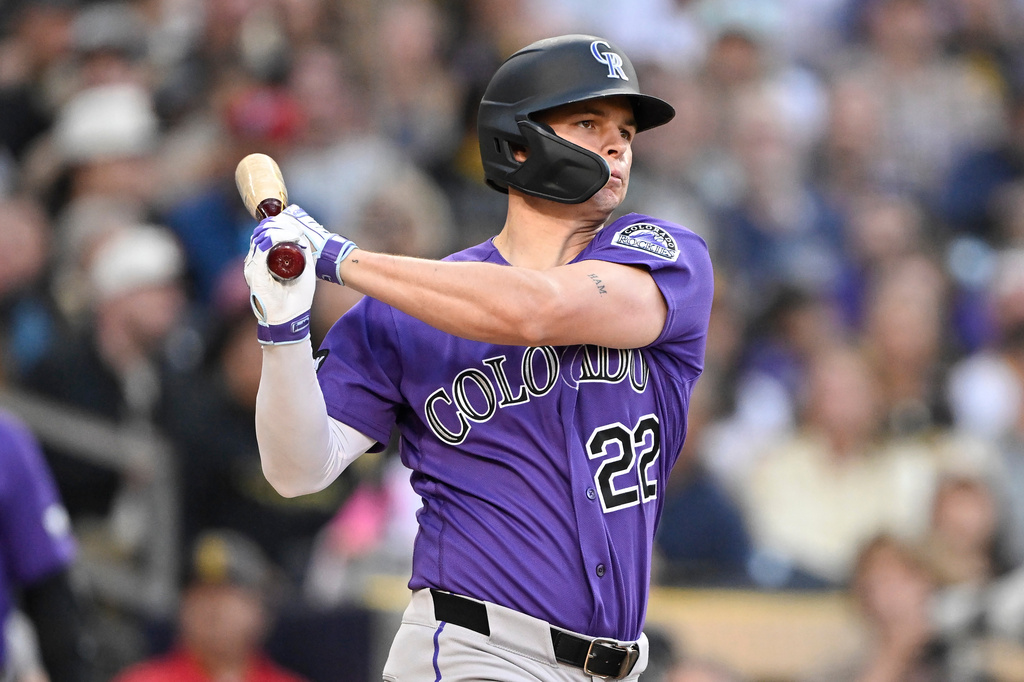 Colorado Rockies' Mickey Moniak (22) hits a solo home run during the third inning of a baseball game against the San Diego Padres Saturday, April 11, 2026, in San Diego. (AP Photo/Denis Poroy)