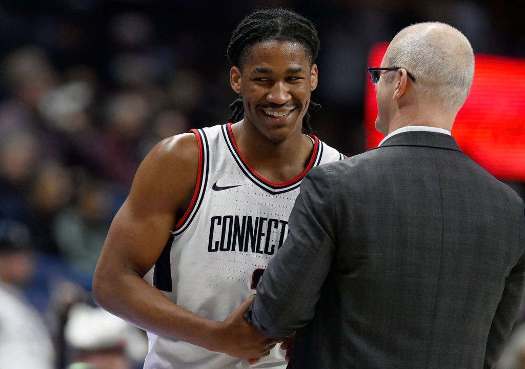 UConn head coach Dan Hurley, right, talks with guard Silas Demary Jr., left, as Demary comes back to the bench in the second half of an NCAA college basketball game against Marquette, Sunday, Jan. 4, 2026, in Storrs, Conn. (AP Photo/Jessica Hill)