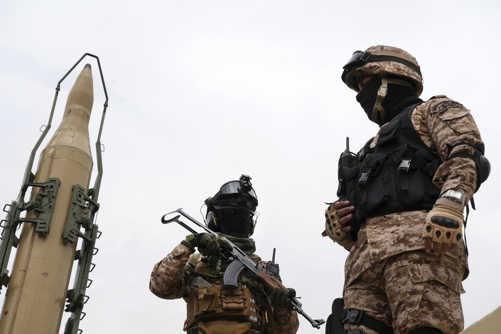 FILE—Iran's Revolutionary Guard members stand in front of Shahab-3 missile which is displayed during the annual pro-Palestinians Al-Quds, or Jerusalem, Day rally in Tehran, Iran, April 29, 2022. (AP Photo/Vahid Salemi, File)