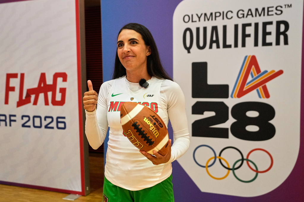 Silvia Contreras, captain of Mexico's women's team, holds a football during the media day ahead of the Flag Football World Championships, the sports first Olympic qualifier for LA28, in Duesseldorf, Germany, Wednesday, Aug. 12, 2026. (AP Photo/Martin Meissner)
