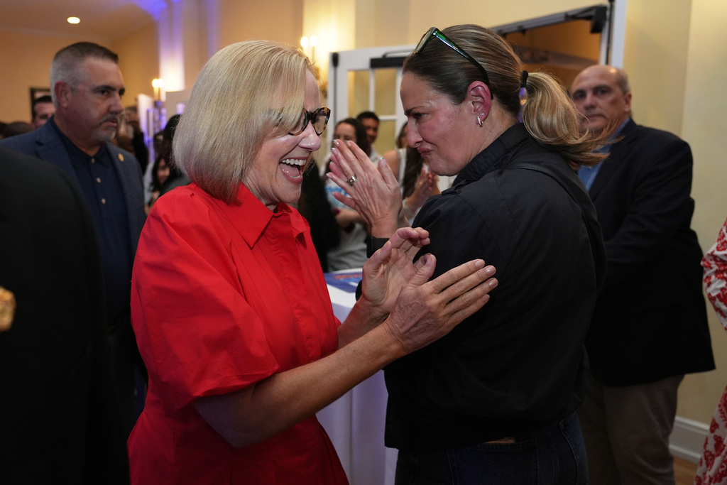 Miami mayor-elect Eileen Higgins, left, celebrates with a supporter at a watch party after winning the Miami mayoral runoff election, Tuesday, Dec. 9, 2025, in Miami. (AP Photo/Lynne Sladky)