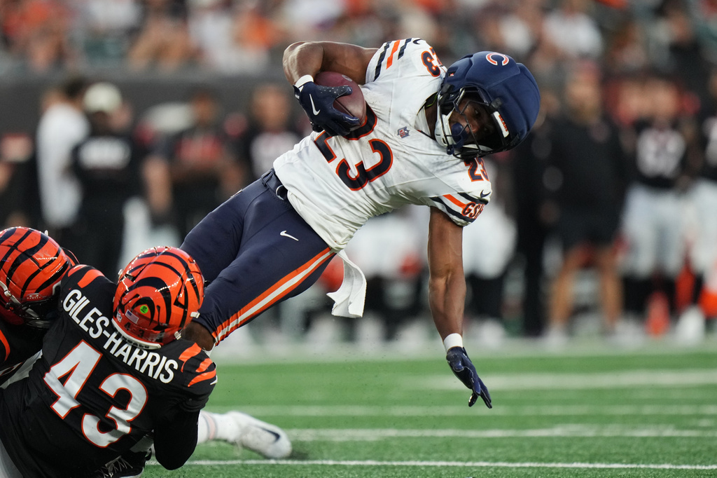 Chicago Bears running back Roschon Johnson (23) falls as he's tackled on a first down by Cincinnati Bengals linebacker Joe Giles-Harris (43) and Bengals safety Russ Yeast during the first half of a preseason NFL football game Saturday, Aug. 22, 2026, in Cincinnati. (AP Photo/Joshua A. Bickel)
