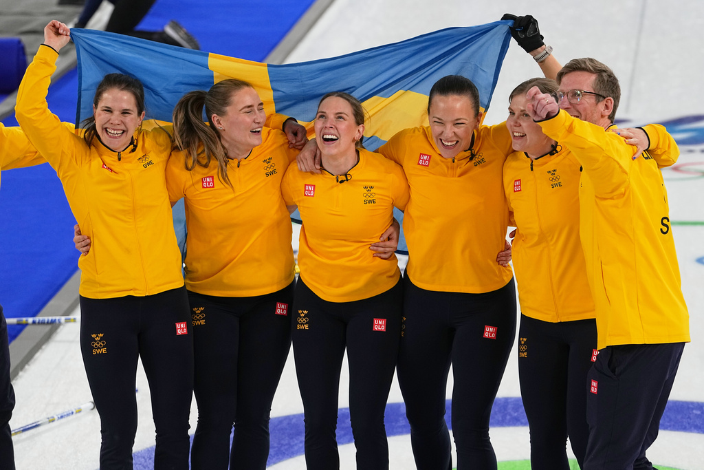 Sweden's Anna Hasselborg, Sara McManus, Sofia Scharback and Agnes Knochenhauer celebrate defeating Switzerland to win a women's curling gold medal match, at the 2026 Winter Olympics, in Cortina d'Ampezzo, Italy, Sunday, Feb. 22, 2026. (AP Photo/Fatima Shbair)