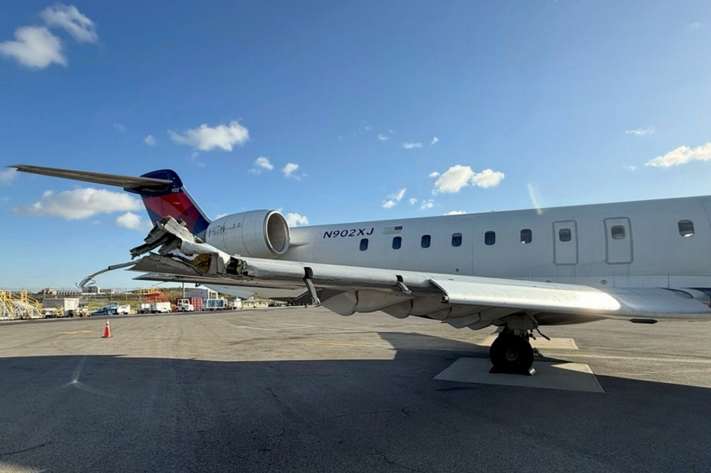 This undated photo provided by a National Transportation Safety Board report Thursday, Nov. 6, 2025, shows damage on the right wing of Flight 5155 sustained during a collision with another aircraft at LaGuardia Airport in New York, Oct. 1, 2025. (National Transportation Safety Board via AP)