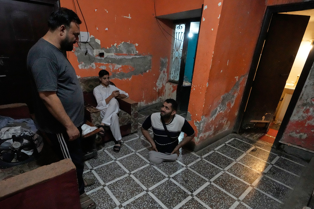 Hamza Ali, 28, who lost both legs in a road accident, spends time with his hostel mates, in Islamabad, Pakistan, Tuesday, July 21, 2026. (AP Photo/Anjum Naveed)