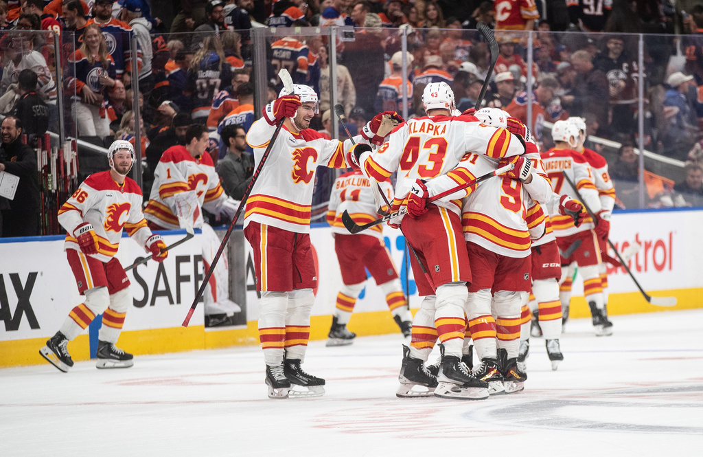 Calgary Flames celebrate their shootout win over the Edmonton Oilers in NHL action, in Edmonton on Wednesday, Oct. 8, 2025. (Jason Franson/The Canadian Press via AP)