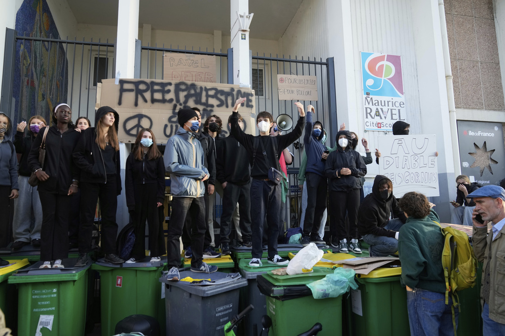 Students block the entrance of a school during a protest called by major trade unions to oppose budget cuts, in Paris, France, Thursday, Sept. 18, 2025. (AP Photo/Michel Euler)