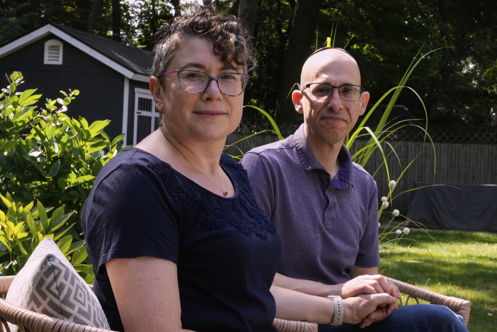 Ziva Mann and her husband Ezra, right, parents of a transgender child and members of a welcoming synagogue, pose in the backyard of their home, Wednesday, Aug. 13, 2025, in Newton, Mass. (AP Photo/Charles Krupa)