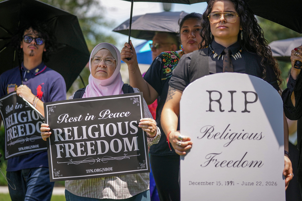 Ruth Nasrullah, left, and Rocio Fierro-Perez, political director for the Texas Freedom Network, participate in an interfaith funeral-themed protest outside the Barbara Jordan Building in Austin on Monday, June 22, 2026. (Jay Janner/Austin American-Statesman via AP)