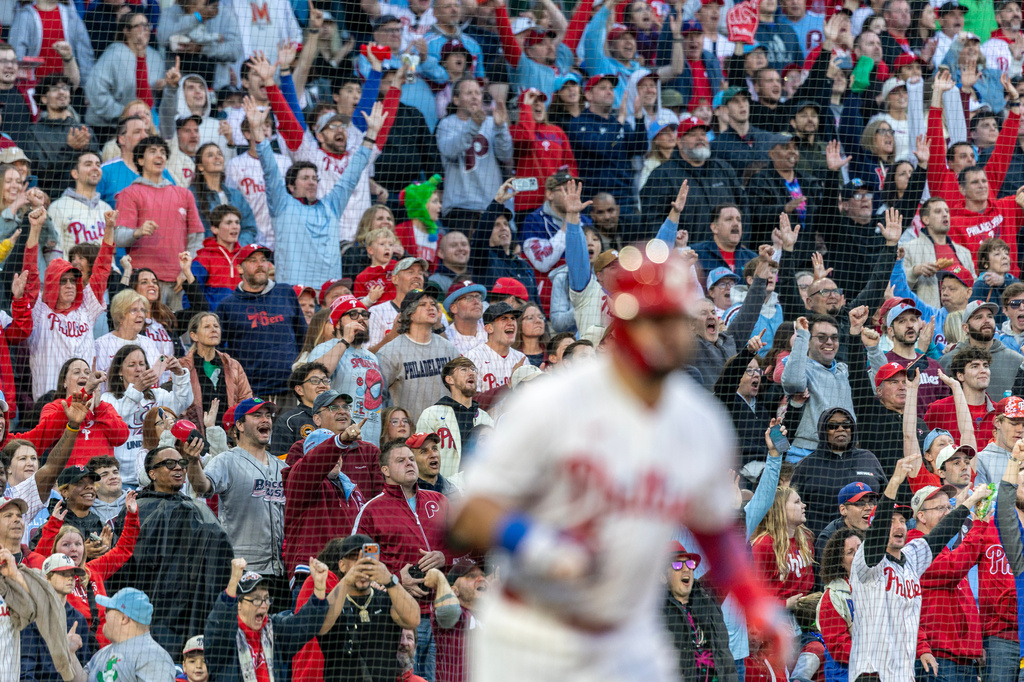 Fans react after Philadelphia Phillies' Kyle Schwarber hit a three-run home runin the third inning of a baseball game against the Colorado Rockies, Saturday, May 9, 2026, in Philadelphia. (AP Photo/Laurence Kesterson)