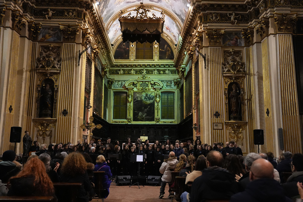 Members of Coro Terzo Tempo gather inside the church of Sant’Antonio Abate before a concert in Milan, Italy, on Feb. 18, 2026. (AP Photo/María Teresa Hernández)
