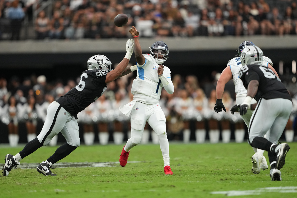 Las Vegas Raiders defensive tackle Jonah Laulu (96) pressures Tennessee Titans quarterback Cam Ward (1) during the first half of an NFL football game, Sunday, Oct. 12, 2025, in Las Vegas. (AP Photo/Rick Scuteri)