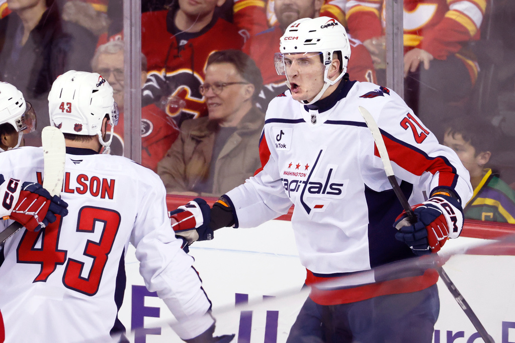 Washington Capitals' Aliaksei Protas, right, celebrates his goal against the Calgary Flames with teammates during the third period of an NHL hockey game in Calgary, Alberta, Friday, Jan. 23, 2026. (Larry MacDougal/The Canadian Press via AP)