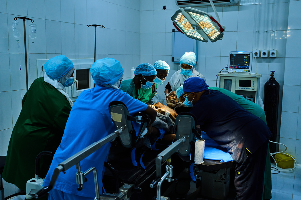 FILE - Medical staffers move a patient to the operation table at Al Nao Hospital in Omdurman, on the outskirts of Khartoum, Sudan, Monday, April 20, 2026. (AP Photo/Bernat Armangue, File)