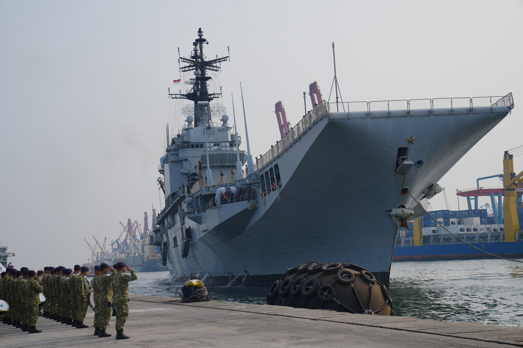 Indonesian Navy personnel salute as the Giuseppe Garibaldi, a former Italian Navy aircraft carrier, arrives at Tanjung Priok port in Jakarta, Indonesia, Friday, Sept. 18, 2026. (AP Photo/Tatan Syuflana)