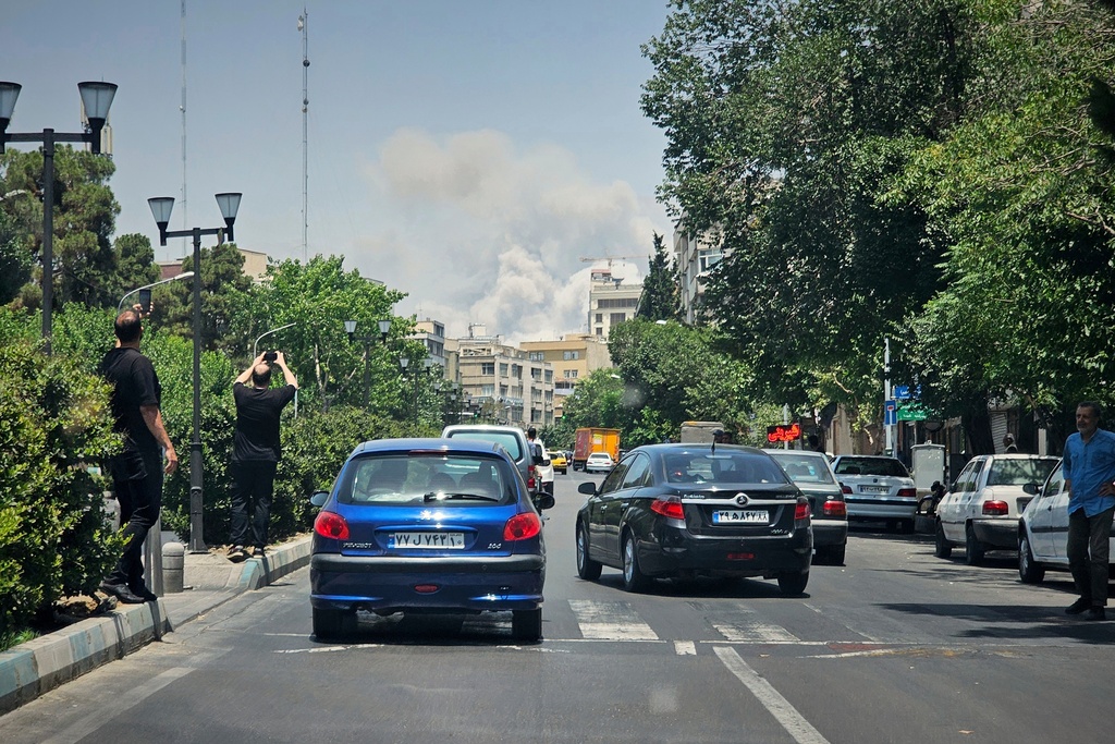 FILE - Residents record smoke rising from an Israeli strike in Tehran, Iran, June 23, 2025. (AP Photo, File)