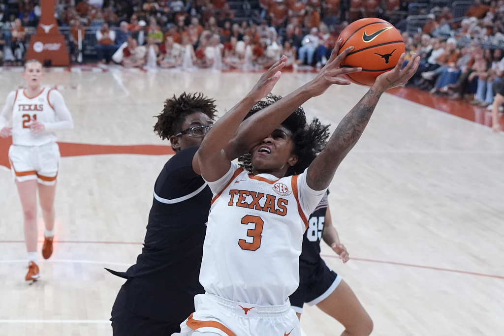Texas guard Rori Harmon (3) drives to the basket against Mississippi State center Rocio Jimenez (13) during the second half of an NCAA college basketball game between Texas and Mississippi State in Austin, Texas, Sunday, Feb. 22, 2026. (AP Photo/Eric Gay)