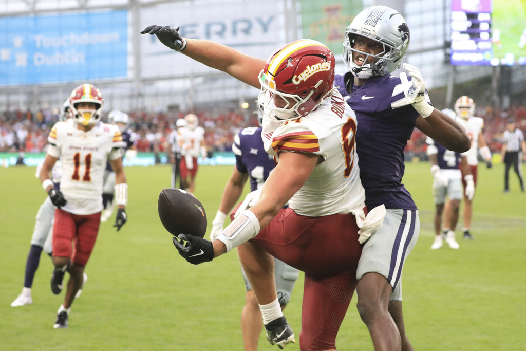 Iowa State Gabe Burkle, left, tries to catch the ball past Kansas State VJ Payne during an NCAA college football game between Iowa State and Kansas State in Dublin, Ireland Saturday, Aug. 23, 2025. (AP Photo/Peter Morrison)