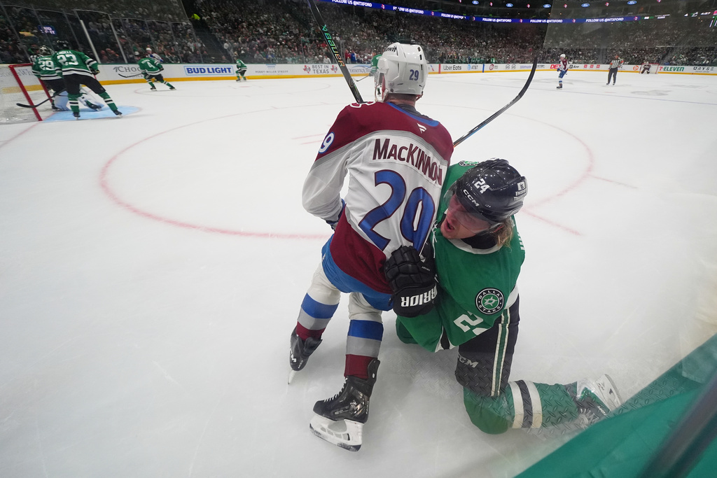 Colorado Avalanche center Nathan MacKinnon (29) and Dallas Stars center Roope Hintz (24) scuffle during the second period of an NHL hockey game Friday, March 6, 2026, in Dallas. (AP Photo/Julio Cortez)