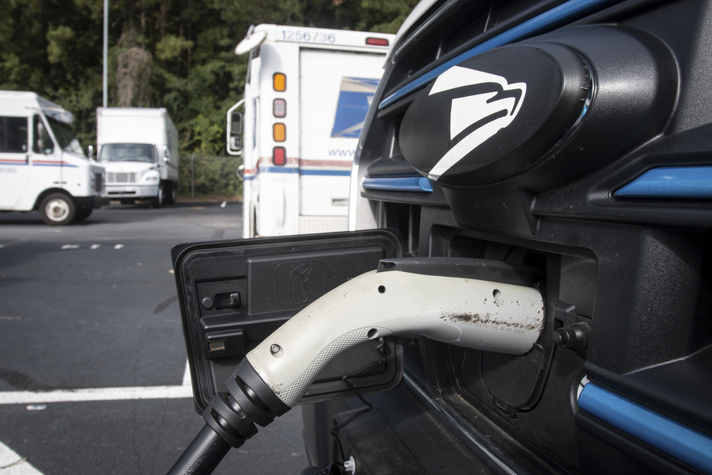 FILE - Mail delivery vehicles are charged at a post office in Athens, Ga., Thursday, Sept. 5, 2024. (AP Photo/Ron Harris, File)