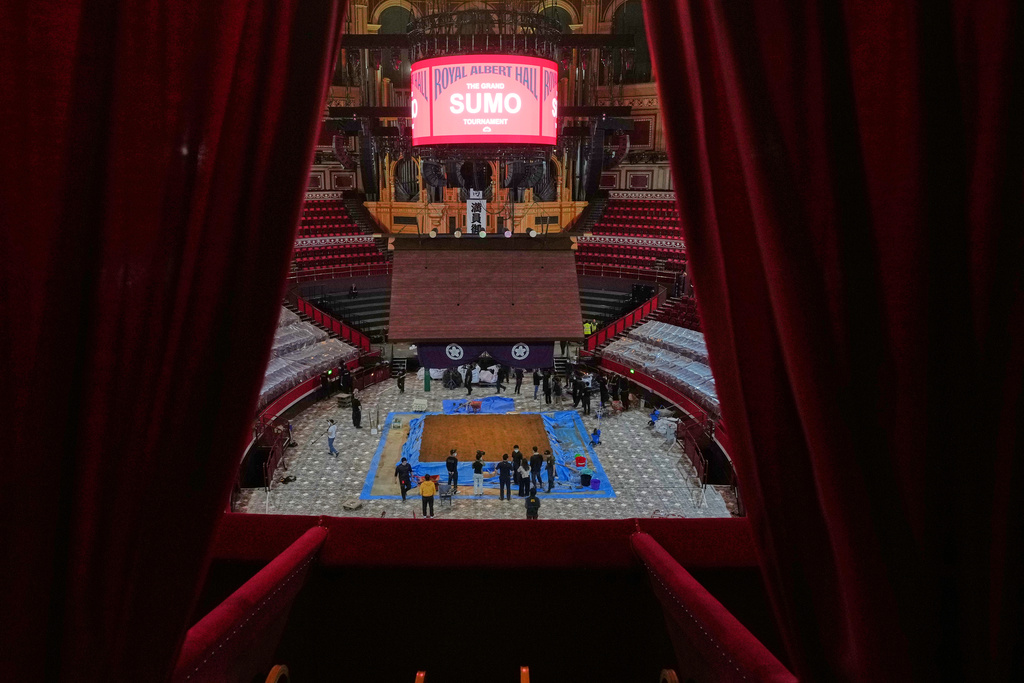 Workers build up the dohyo, the sacred sumo wrestling ring and the ceremonial heart of the event, during a ritualized process that combines centuries-old tradition with precise engineering at the Royal Albert Hall in London, Monday, Oct. 13, 2025 ahead of The Grand Sumo Tournament. (AP Photo/Frank Augstein)